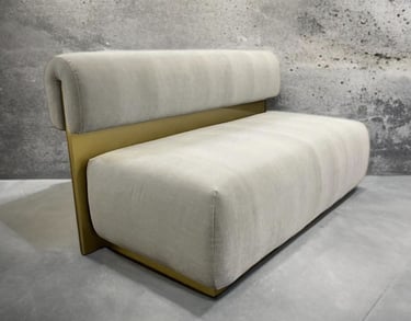 Modern bench with plush cream cushions and gold metal back, by Solo Home Decor.