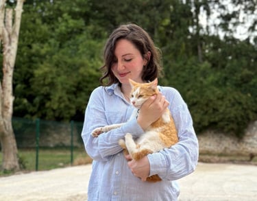 a woman holding a cat in her arms