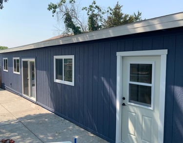 a blue garage with a white door and a white door