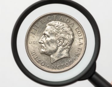 A photograph of a magnifying glass enlarging the date on a rare silver coin. Bright, clean, professional lighting. North American / US context.