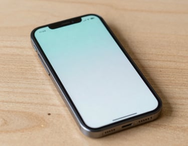 A close-up photograph of a modern smartphone resting on a light wood table, displaying a clean and soft user interface with light aqua accents, North American / US setting.