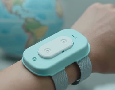 A close-up of an innovative wearable health sensor being used in a medical setting, North American / Global context. Professional photography with soft focus on the background, using a palette of light cyan and grey.