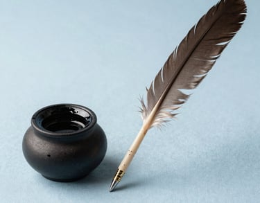 A minimalist composition of a traditional Indian ink pot and a feather quill resting on a light blue fabric, representing intellectual depth and creative passion.
