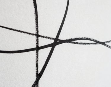 Detail of a white wall with an abstract, minimalist ink drawing. High contrast, elegant editorial style, artistic composition.