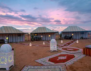 Luxury Sahara desert camp experience with private tents and evening atmosphere in Morocco