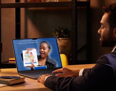 Man watching a video about a faith-based adventure book on his laptop in a cozy office setting.