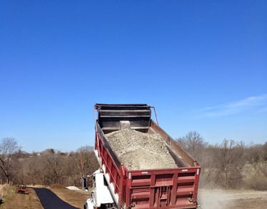 truck tail gating a gravel driveway