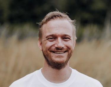 a man with a beard and a beard, smiling