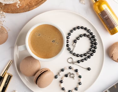 a cup of coffee and a rosary on a plate