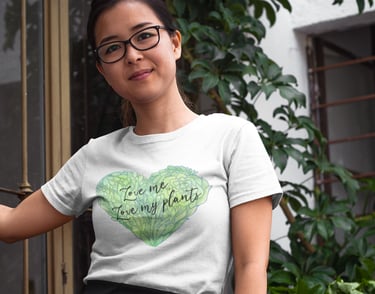 Woman wearing Miss Chatty Plants “Love Me, Love My Plants” white t-shirt with green heart design