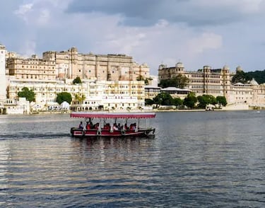 Boat ride on Lake Pichhola with City Palace Udaipur in the background.