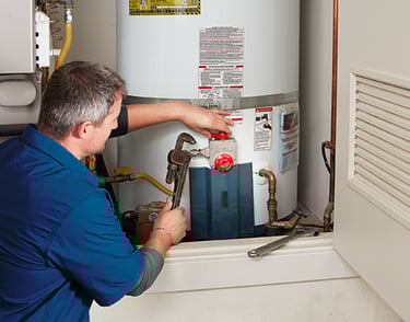 Certified plumber installing water heater in Dubai home for reliable hot water