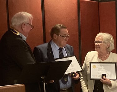 2024-25 President Keith presents Past President Rod and wife Annette with Paul Harris Fellow awards