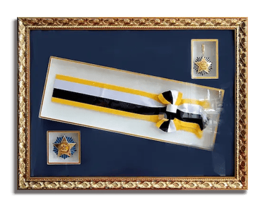 A client's important keepsakes - medals and ribbon, framed in a gold and dark blue themed frame
