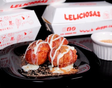 a plate of doughnuts with a cup of coffee