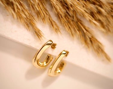gold hoop earrings product photography UK, styled with wheat on white background - Basma Lens