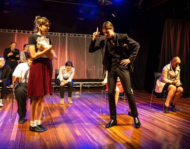 a man and woman in a stage setting