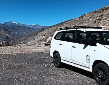 a white van parked in front of a mountain