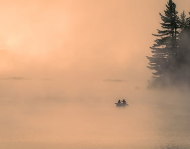 a couple of people in a boat on a lake
