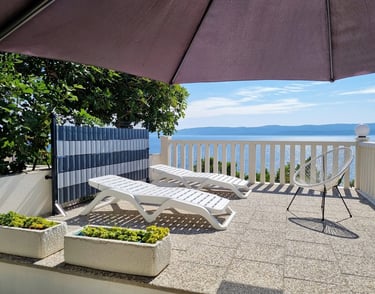 The photograph shows an easter sun terrace and the sea.