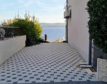 The picture shows private parking for guests and a sea view.