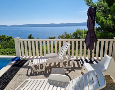 The photo shows a west sun terrace and a sea view.