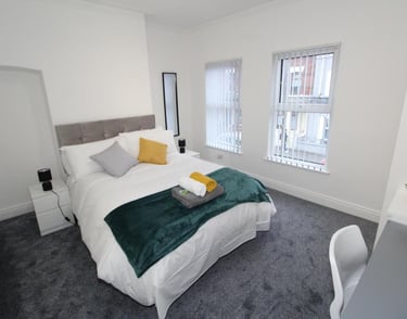 bedroom with bed and white walls
