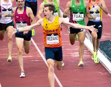a group of men running in a race track