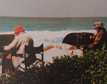 Artists painting on a beach