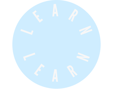 a circular blue sign with the words learn in white letters