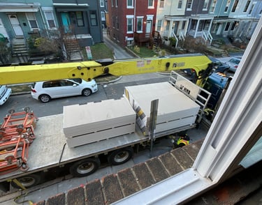 a truck with a trailer parked in front of a house