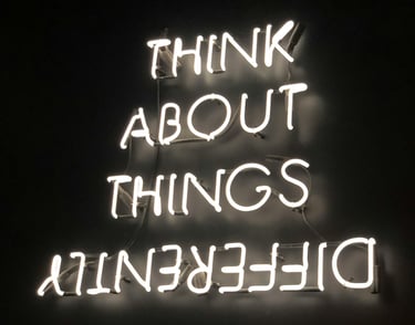 a neon sign that says think about things that are difficult to do