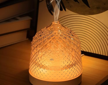 a small glass diffuser with smoke coming out of it