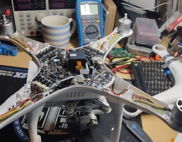 a table with electronics and electronics on it , drone for repair