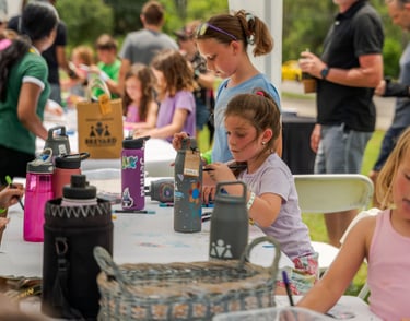 a group of children and adults sitting at a table