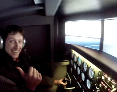 a man in a pilot's seat in a flight simulator
