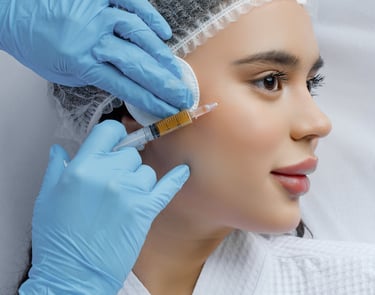 a woman in a white robe is getting her eyebrows done