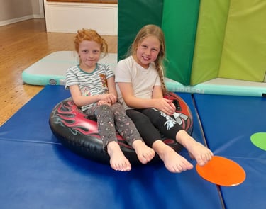 two girls practicing pointy toes in SEND gymnastics session