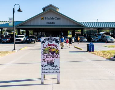 Photo taken of the Columbia Farmer's Market sign in front of the Farmer's Market pavilion