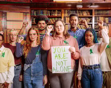 a group of people standing with the words you are not alone written on paper