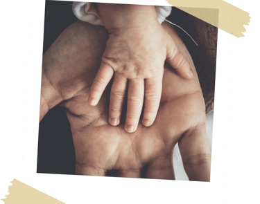 Father holding a baby's hand