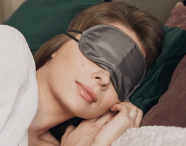 woman sleeping with eye covers