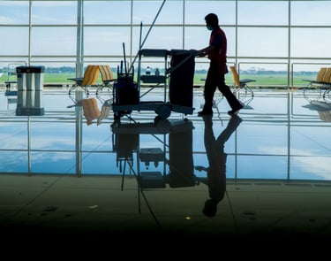a man walking through a large room with chairs and chairs