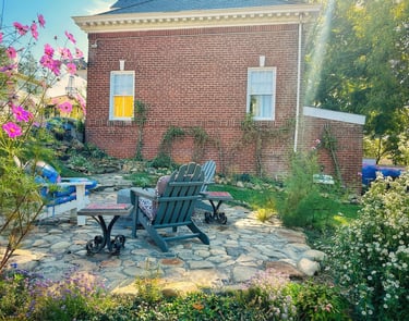 brick carriage house and stone patio with adirondack chairs 2123 rivermont