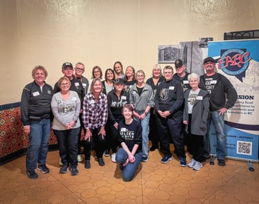 A group of volunteers smiling together for a group photo