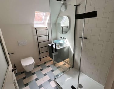a bathroom with a shower and a toilet fitted by pbp services