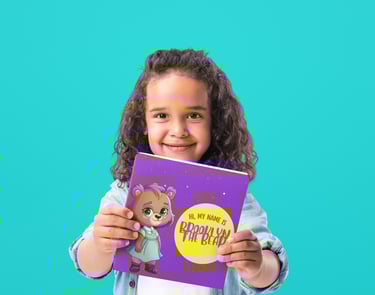 young girl holding a book up
