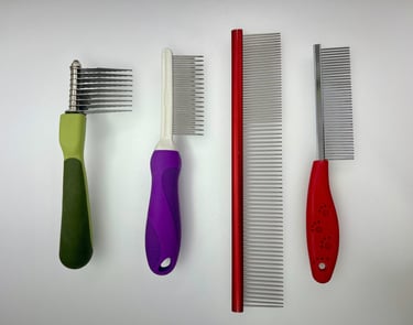 Professional dog grooming combs and dematting tools used for coat care, detangling, and finishing