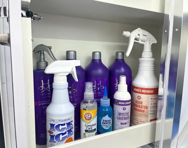 Premium dog shampoos, conditioners, cologne, dental care, and grooming products stocked inside a van