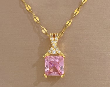 a pink princess cut diamond necklace with a pink and gold necklace